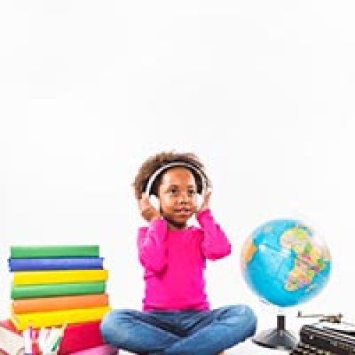girl-headphones-near-books-globe-studio